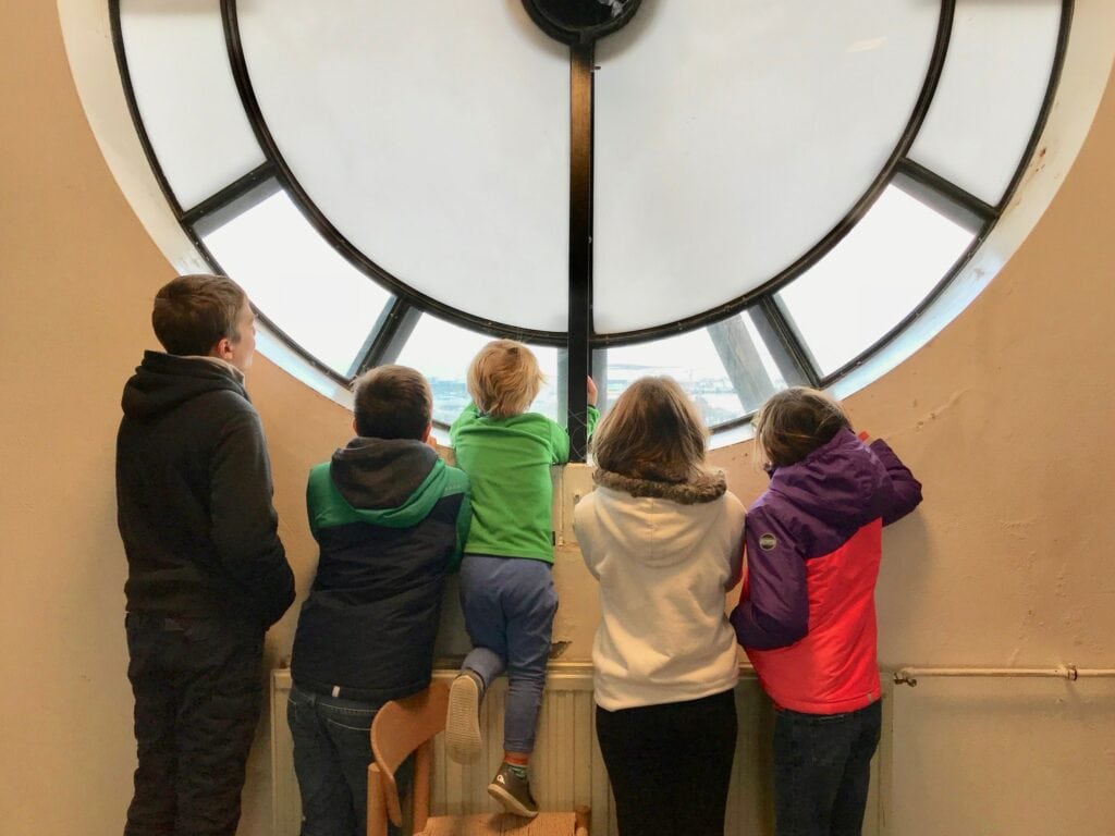 Things to do in Iceland with kids Kids looking out the tower window at Hallgrímskirkja Lutheran Church