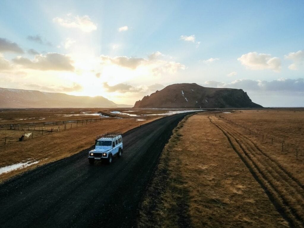 4x4 vehicle driving on a remote gravel road in Iceland’s Highlands