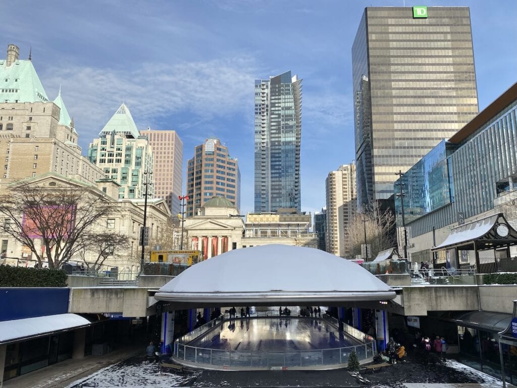 Robson Square Skating Rink Vancouver with the cityscape in the background.,