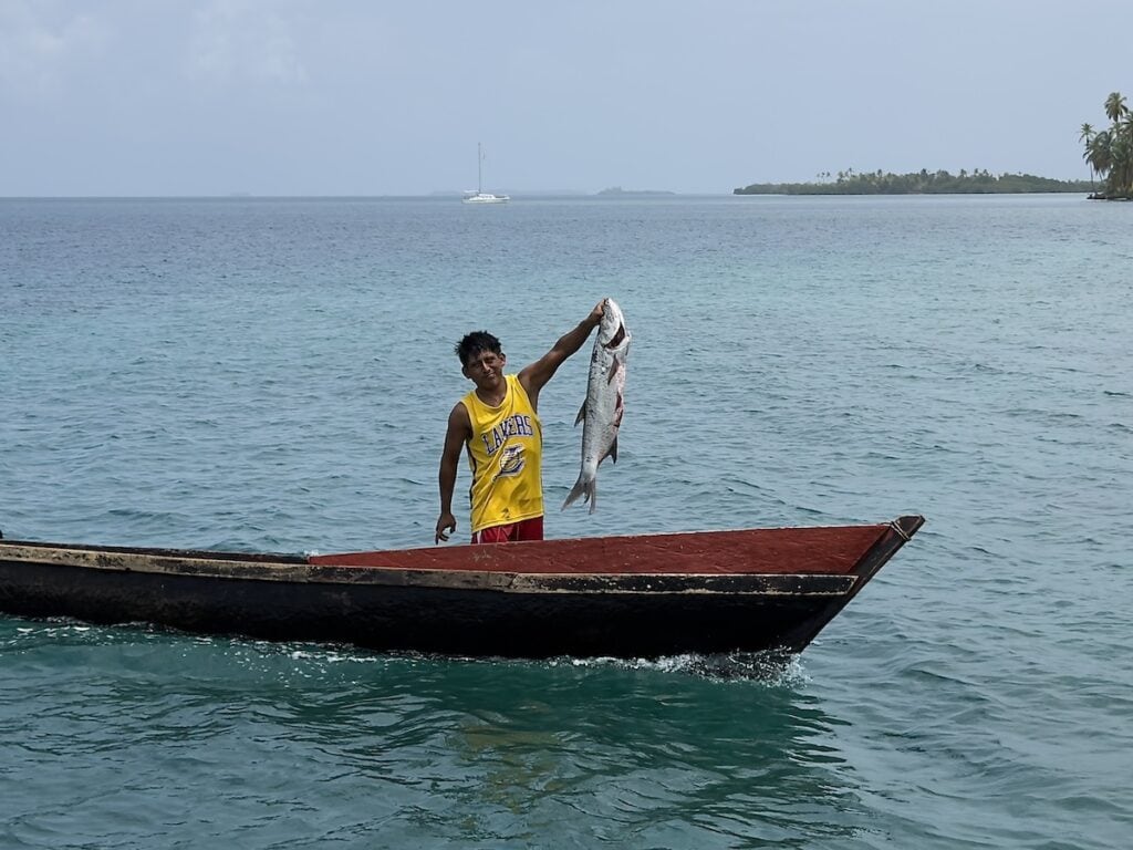 Fisherman holding up a fish in the Guna Yala
