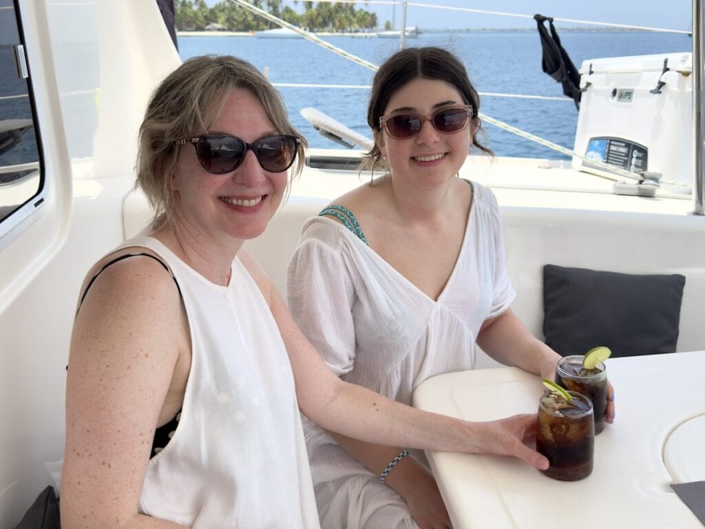 Mother and daughter sipping Cuba Libres on board the Kaya catamaran in Guna Yala