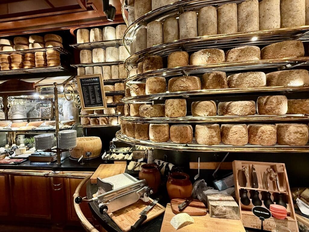 A wall of cheese rounds at Les Grands Buffets in Narbonne, France